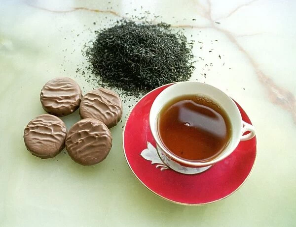 Cup of black tea with chocolate biscuits