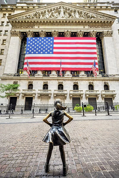 'Fearless Girl'bronze sculpture by artist Kristen Visbal across from the New York Stock Exchange Building, Lower Manhattan, New York, USA