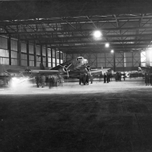 Night-time hangar scene with a Douglas DC-3 of KLM