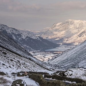 View of upland valley covered in snow, looking towards Brothers Water from Kirkstone Pass, Lake District, Cumbria