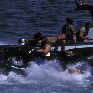 Navy SEALs practice high speed boat cast and recovery