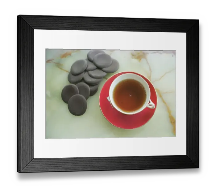 Framed Print : Cup of black tea with chocolate rounds