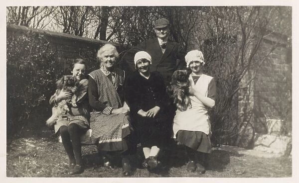 Family group with two dogs in a garden