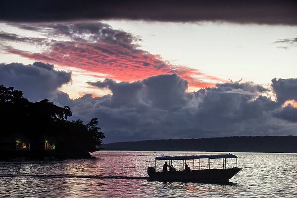 Tourist boat driving back home at sunset in Port Vila, Efate, Vanuatu, Pacific