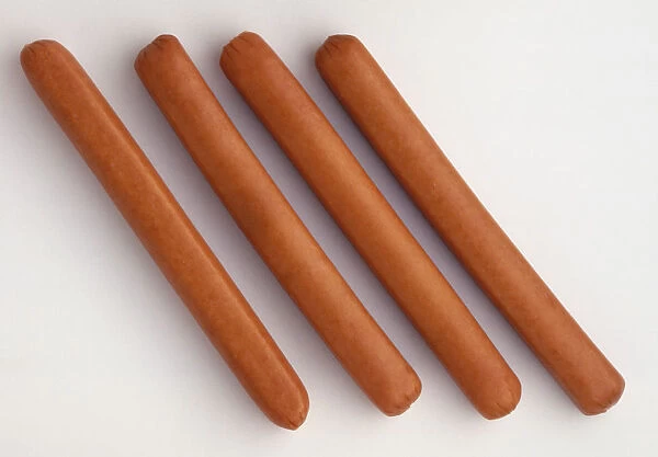 Above view of four frankfurter sausages