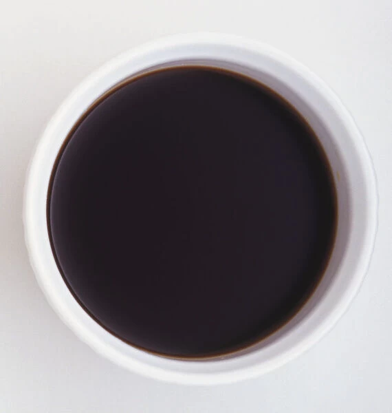 Above view of soy sauce in circular white dish