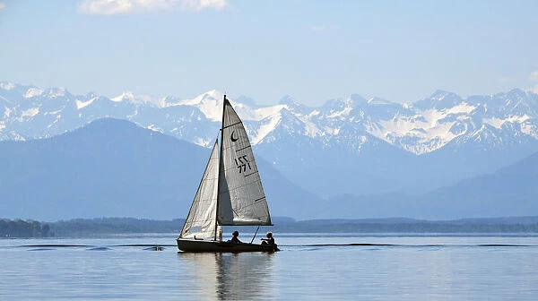 Sail boat on lake Starnberger See against Alps panorama