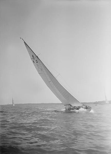 The 8 Metre class sailing yacht Carron (K2), heeling upwind in a good breeze, 1934