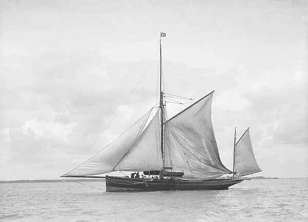 The yawl Roma raising main sail, 1912. Creator: Kirk & Sons of Cowes