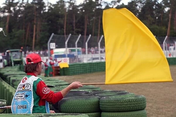 Formula One World Championship: A marshal waves a yellow flag