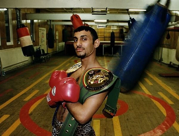 Prince Naseem Hamed in Sheffield gym with the WBC & IBO title belts looking smug proud