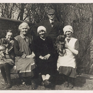 Family group with two dogs in a garden