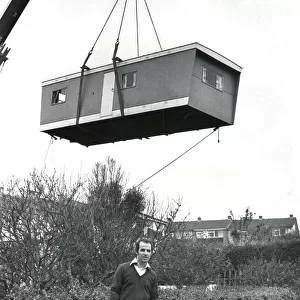 Prefabricated unit delivered to a garden by crane