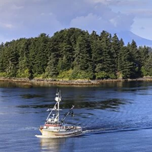 Commercial fishing boat and small forested island, rare summer sun, Sitka Sound, Sitka