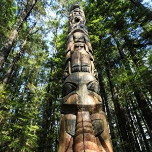 Lakich inei Pole, Tlingit totem pole, lit by sun in rainforest, Sitka National Historic Park