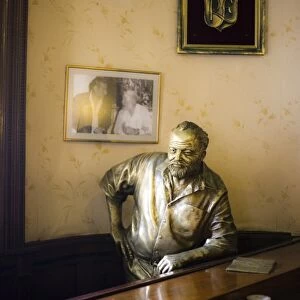 Lifesize bronze statue of author Ernest Hemingway in bar El Floridita, Havana
