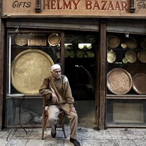 Shop owner relaxes in the great bazaar of Khan al-Khalili, Cairo, Egypt, Africa