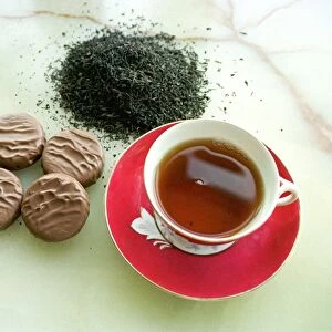 Cup of black tea with chocolate biscuits