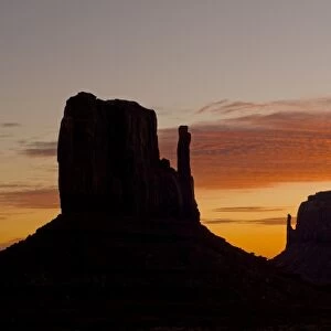 The west and east Mitten buttes silhouetted at sunset, Monument Valley, Navajo Tribal Park, Arizona