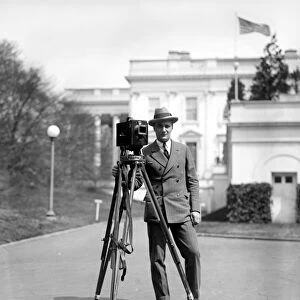 PHOTOGRAPHER, c1915. A photographer with his camera and tripod, outside the White