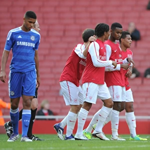 Zak Ansah celebrates scoring Arsenals goal with Phillip Roberts and Serge Gnabry