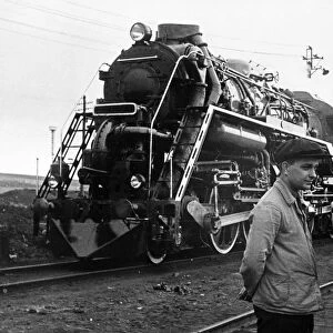 The first soviet steam-and-internal combustion locomotive with its inventor and chief builders, november 1939, (left to right) d, lvov, l, maizel (inventor), and p, soroka