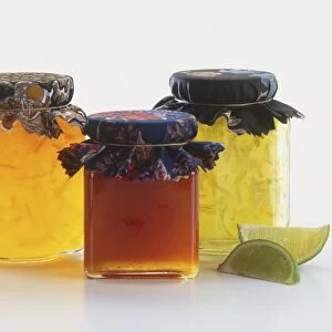 Jars of marmalade, lime jam and red-coloured jam