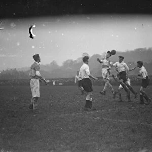 Boys football, two players compete for an aerial ball. 1935