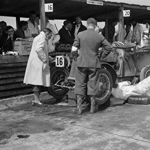 Mechanic working on a Lea Francis J type at the JCC Double Twelve race, Brooklands, May 1931