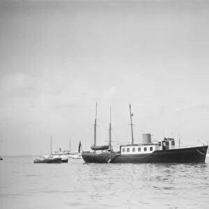 The twin screw 80ft motor yacht Bystander at anchor, 1934. Creator: Kirk & Sons of Cowes