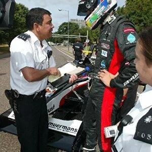 Thunder In Hyde Park: Justin Wilson, Minardi, is given a speeding ticket by the police