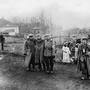 German Red Cross workers near Lowicz, Poland help an injured German pilot to a field