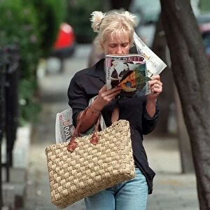 Paula Yates TV Presenter August 1998 Walking down the street reading a magazine