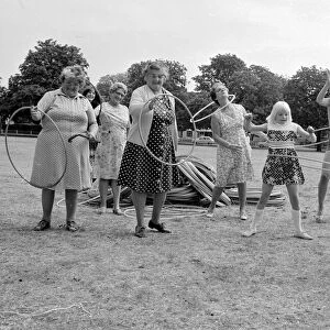 Pensioners playing with Hula Hoops in a Twickenham park. August 1976 P76 734