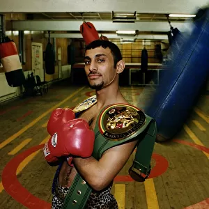 Prince Naseem Hamed in Sheffield gym with the WBC & IBO title belts looking smug proud